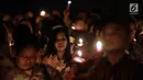 Jemaat menyalakan lilin dalam acara Natal Taruna Merah Putih di Jakarta, Jumat (22/12). Natal 2017 mengusung tema 'Konser Bersama Tuhan Yesus di Danau Toba' (Liputan6.com/Faizal Fanani)