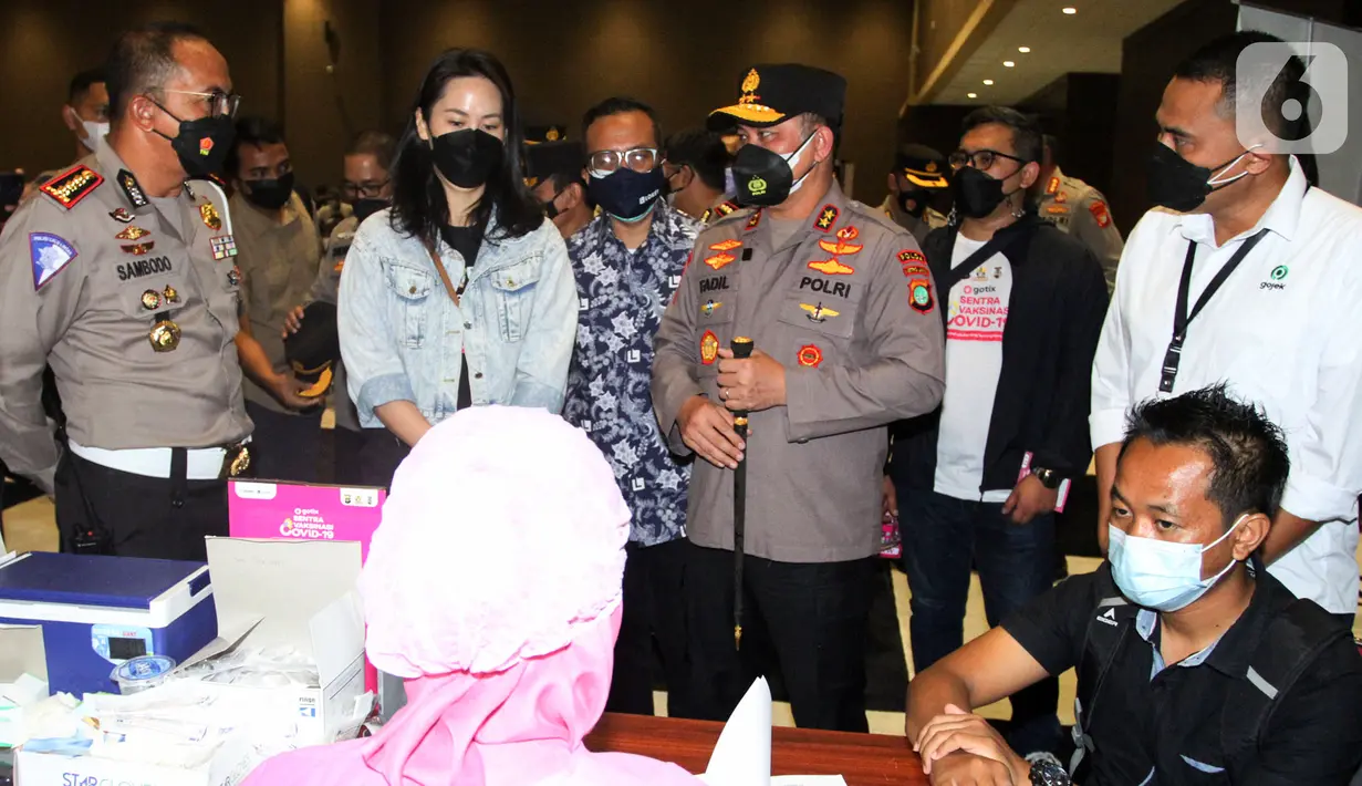 Dirlantas Polda Metro Jaya Kombes Sambodo Purnomo Yogo, VP of GoTix Business Edwina Tirta, Head of GoTix Tubagus Utama, Kapolda Irjen Muhammad Fadil Imran dan VP Kebijakan Publik dan Hubungan Pemerintah Gojek Gautama Adi meninjau vaksinasi massal di JIEXPO Kemayoran (27/06). (Liputan6.com/HO/Ading)