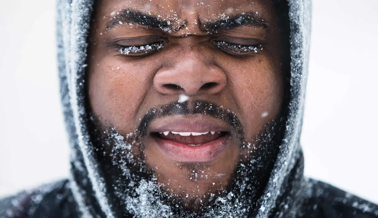 Ajamu Gumbs dari New York menuju ke sebuah stasiun bis saat badai salju di Atlantic City, N.J., (4/1). Badai salju yang melanda sebagian Amerika Serikat telah membawa salju dan angin kencang. (AP Photo / Matt Rourke)