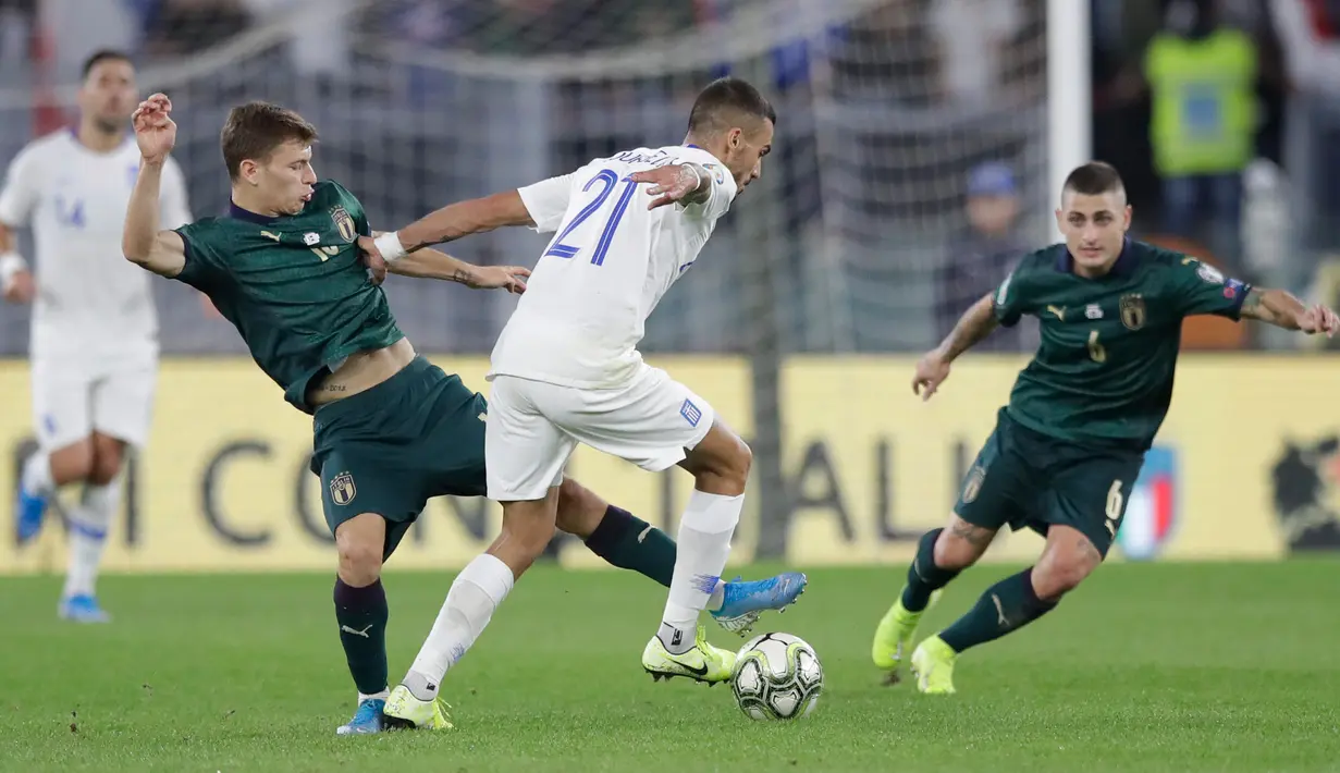 Gelandang timnas Italia, Nicolo Barella berebut bola dengan pemain timnas Yunani, Dimitris Kourbelis pada pertandingan grup J babak kualifikasi Piala Eropa 2020 di Stadio Olimpico, Sabtu (12/10/2019). Italia lolos ke putaran final setelah mengalahkan Yunani 2-0. (AP/Alessandra Tarantino)