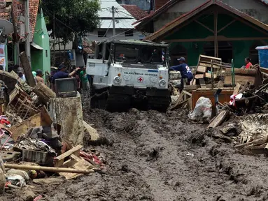 PMI mengerahkan kendaraan Hagglund di Kampung Bojong Sudika, Cimacan, Garut, Jumat (23/9). Kendaraan hagglund guna mempermudah mobilisasi sukarelawan dan proses evakuasi di tengah kawasan yang penuh lumpur akibat banjir bandang. (Liputan6.com/Johan Tallo)