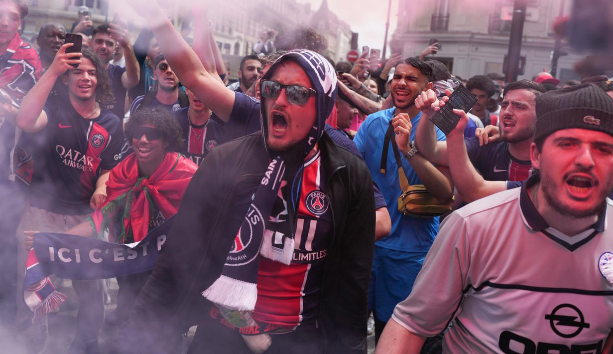 Suporter Paris Saint-Germain merayakan keberhasilan juara Liga Champions di kota Paris. (AFP/Thibaud Moritz)