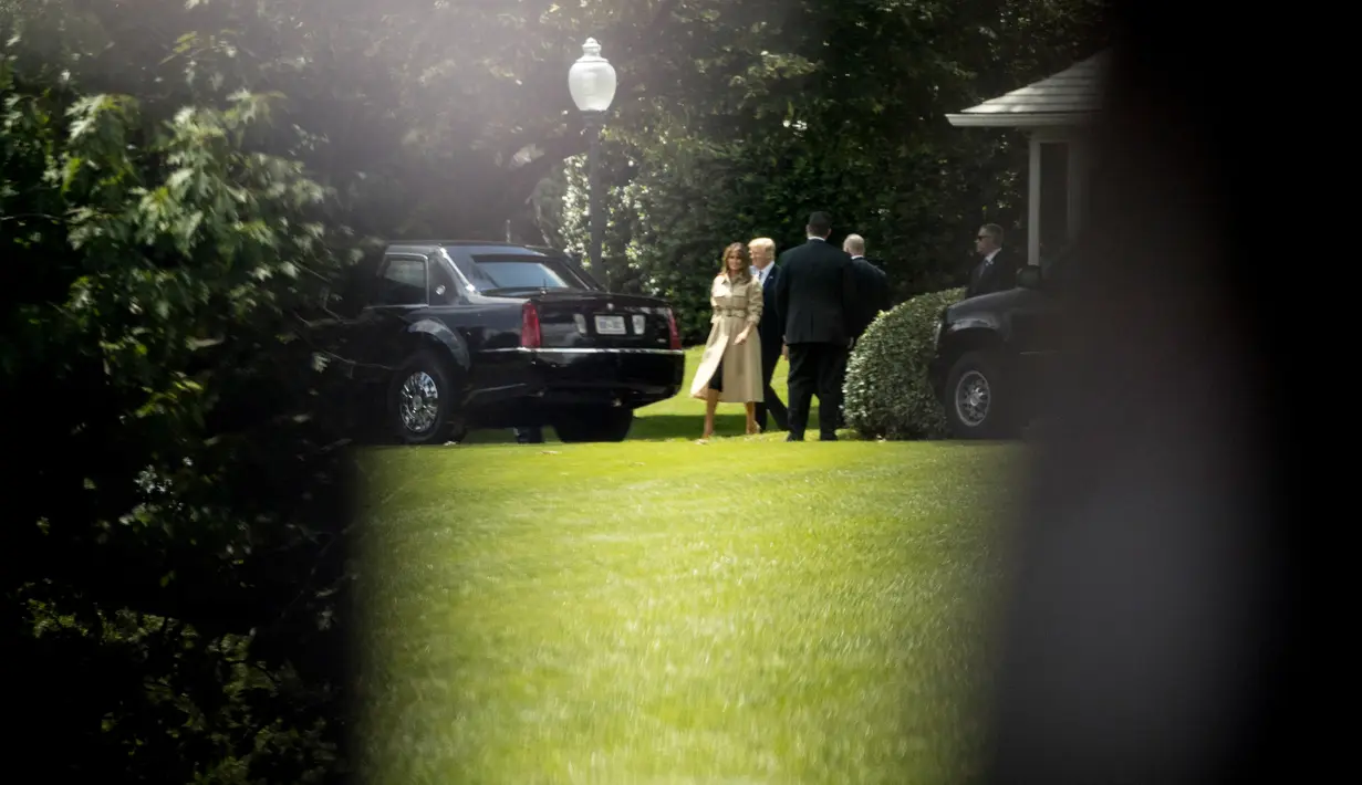 Presiden AS, Donald Trump dan Melania Trump berjalan gedung oval menuju iring-iringan mobil di depan Gedung Putih, Washington, Rabu (6/6). Trump dan Melania saat itu akan menuju markas besar Federal Emergency Management Agency (FEMA). (AP/Andrew Harnik)