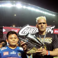 Pemain Arema FC, Cristian Gonzales bersama putranya memamerkan trofi pencetak gol terbanyak Piala Presiden 2017 di Stadion Pakansari, Minggu (12/3). Cristian Gonzales meraih gelar pencetak gol terbanyak dengan 11 gol. (Liputan6.com/Helmi Fithriansyah)
