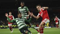 Pemain Arsenal, Leandro Trossard dikepung dua penggawa Sporting CP pada leg kedua babak 16 besar Liga Europa 2022/2023 di Stadion Emirates, Jumat (17/3/2023) dini hari WIB. (AP Photo/Ian Walton)