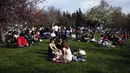 Orang-orang duduk di sebuah taman di Ankara, sehari sebelum penerapan "penguncian penuh" atau lockdown, Rabu (28/4/2021). Turki akan memberlakukan lockdown penuh selama tiga minggu dari 29 April hingga 17 Mei 2021 untuk membendung penyebaran virus corona. (AP Photo/Burhan Ozbilici)