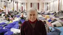 Nellya Nahorna, 85 tahun, yang melarikan diri dari invasi Rusia dari Zaporizhzhia bersama putrinya Olena Yefanova, berpose di dalam ballroom yang diubah menjadi tempat penampungan pengungsi darurat di hotel & spa bintang 4, di Suceava, Rumania, 4 Maret 2022. (AP Photo/Andreea Alexandru)