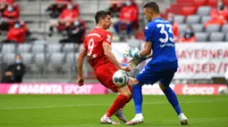 Pemain Bayern Munchen, Florian Kastenmeier, berebut bola dengan pemain Fortuna Duesseldorf, Florian Kastenmeier, pada laga Bundesliga di Allianz Arena, Sabtu (30/5/2020). Bayern Munchen menang 5-0 atas Fortuna Duesseldorf. (AP/Christof Stache)