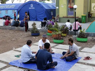 Para pencari suaka duduk-duduk di halaman gedung bekas Markas Kodim di kawasan Kalideres, Jakarta, Selasa (16/7/2019). Rata-rata para pencari suaka tersebut berasal dari Afghanistan, Pakistan, Somalia, Sudan, Iraq, dan Iran. (Liputan6.com/Helmi Fithriansyah)