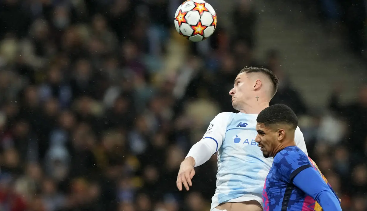 Bek Barcelona Ronald Araujo berduel memperebutkan bola dengan gelandang Dynamo Kyiv Benjamin Verbic pada Matchday 4 Liga Champions di NSK Olimpiyskiy, Rabu (3/11/2021) dini hari WIB.  Barcelona menang tipis 1-0 saat bertamu ke markas Dynamo Kiev. (AP Photo/Efrem Lukatsky)
