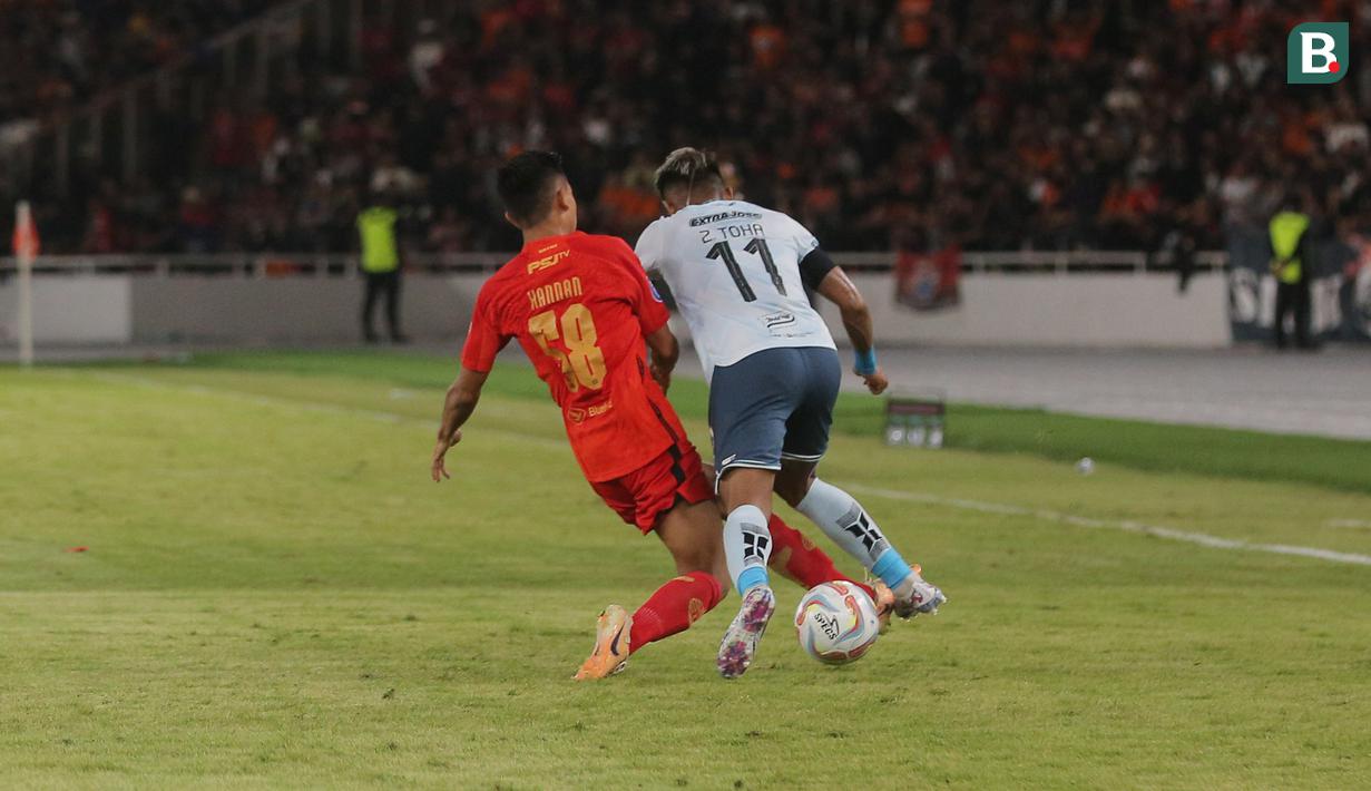 Pemain Persija Jakarta, Rayhan Hannan, berusaha merebut bola dari pemain Persita Tangerang, Muhammad Toha, pada laga pekan ke-21 BRI Liga 1 di Stadion Utama Gelora Bung Karno (SUGBK), Jakarta Pusat, Minggu (3/12/2023). (Bola.com/M Iqbal Ichsan)