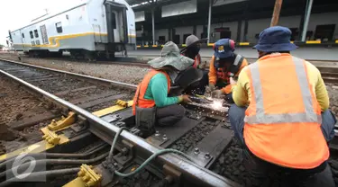 Sejumlah pekerja memperbaiki rel jalur Kerata Api di Stasiun Tugu, Yogyakarta, Selasa (28/6). Perbaikan di lakukan untuk memperlancar arus mudik dengan menggunakan transportasi layanan kereta api. (Liputan6.com/Boy Harjanto)