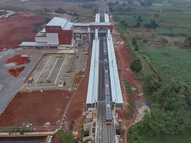 Foto udara memperlihatkan rangkaian KRL Commuter Line melintas di samping proyek pembangunan Stasiun Jatake, Pagedangan, Kabupaten Tangerang, Banten, Selasa (29/7/2025). (merdeka.com/Arie Basuki)