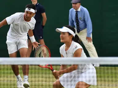 Petenis Indonesia Christopher Rungkat dan Shuko Aoyama dari Jepang mengembalikan bola ke petenis Kroasia Nikola Mektic dan Alicja Rosolska dari Polandia pada putaran kedua ganda campuran Wimbledon 2019 di All England Lawn Tennis Club, Senin (8/7/2019). Christo/Aoyama kalah 5-7, 4-6. (GLYN KIRK/AFP)