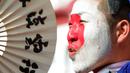 A Japan supporter cheers ahead of the England vs Japan Group B match of the FIFA women's football World Cup on July 5, 2011 in Augsburg, Southern Germany.  AFP PHOTO / CHRISTOF STACHE (Photo by Christof STACHE / AFP)