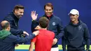 Petenis Spanyol, Rafael Nadal (tengah) memberi selamat kepada rekannya, Pablo Carreno Busta usai mengalahkan petenis Australia, John Millman dalam Turnamen Tenis ATP Cup di Melbourne, Selasa (2/2/2021). Spanyol menang 3-0 atas Australia. (AFP/David Gray)