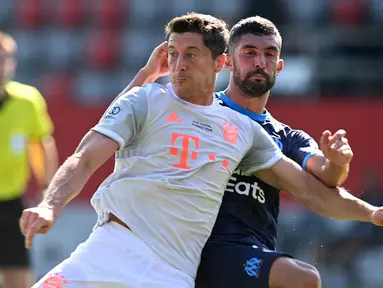 Penyerang Bayern Munchen, Robert Lewandowski, berebut bola dengan bek Marseille, Alvaro Gonzalez, pada laga persahabatan di Allianz Arena, Sabtu (1/8/2020) dini hari WIB. Bayern Munchen menang 1-0 atas Marseille. (AFP/Christof Stache/various sources)