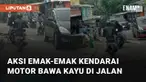 Aksi membahayakan dilakukan oleh seorang emak-emak saat kendarai motor membawa kayu di jalan