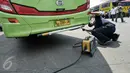 Petugas melakukan uji emisi bus yang akan digunakan untuk armada Lebaran di Terminal Kampung Rambutan, Jakarta, Jumat (24/6). Dishub DKI melakukan tes kesehatan pengemudi dan pengecekan bus jelang arus mudik 2016. (Liputan6.com/Yoppy Renato)