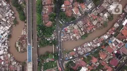 Foto udara suasana Sungai Ciliwung yang diapit pemukiman padat penduduk di kawasan Manggarai, Jakarta, Selasa (7/1/2020). Pemprov DKI Jakarta akan membebaskan 118 bidang lahan untuk proyek normalisasi Sungai Ciliwung pada tahun 2020 yang tersebar di empat kelurahan. (Liputan6.com/Immanuel Antonius)