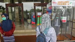Petugas Medis berada di dalam bilik disinfektan di Hotel Grand Cempaka , Jakarta, Sabtu (28/3/2020). Hotel ini disediakan oleh Pemprov DKI sebagai tempat istirahat 343 tenaga medis, 28 di antaranya dokter, yang menangani kasus Corona Covid-19 di ibu kota. (Liputan6.com/Herman Zakharia)