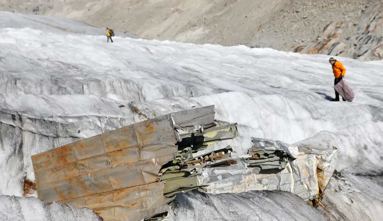 Bagian pesawat tempur Perang Dunia II milik AS saat ditemukan di Gauli Glacier, di Bernese Alps, Swiss (17/9). Pesawat Perang Dunia II C-53 Skytrooper Dakota tersebut jatuh tahun 1946. (Peter Klaunzer/Keystone via AP)