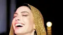Tren hooded gown kembali. Penampilan ikonis yang terlihat dikenakan oleh Anne Hathaway. Di acara BVLGARI, Anne tampil menawan dengan hooded gown bernuansa keemasan dari Versace. Foto: Instagram.