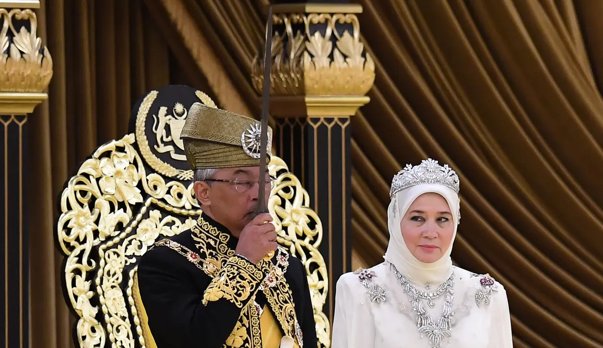 Raja Malaysia Abdullah Ri'ayatuddin Al-Mustafa Billah Shah (kiri) mencium keris disaksikan Ratu Tunku Azizah saat penobatan kerajaan di Istana Nasional, Kuala Lumpur, Selasa (30/7/2019). Penobatannya datang setelah pengunduran diri Sultan Kelantan Muhammad V. (Malaysia Information Ministry via AP)