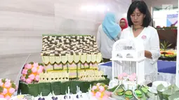 Peserta menunjukkan hasil karyanya saat mengikuti lomba kreasi jajanan pasar di Jakarta, Rabu (20/2). Sebanyak 43 peserta mengikuti lomba yang digelar dalam rangka Munas 2019 Asosiasi Perusahaan Jasaboga Indonesia (APJI). (Liputan6.com/Angga Yuniar)