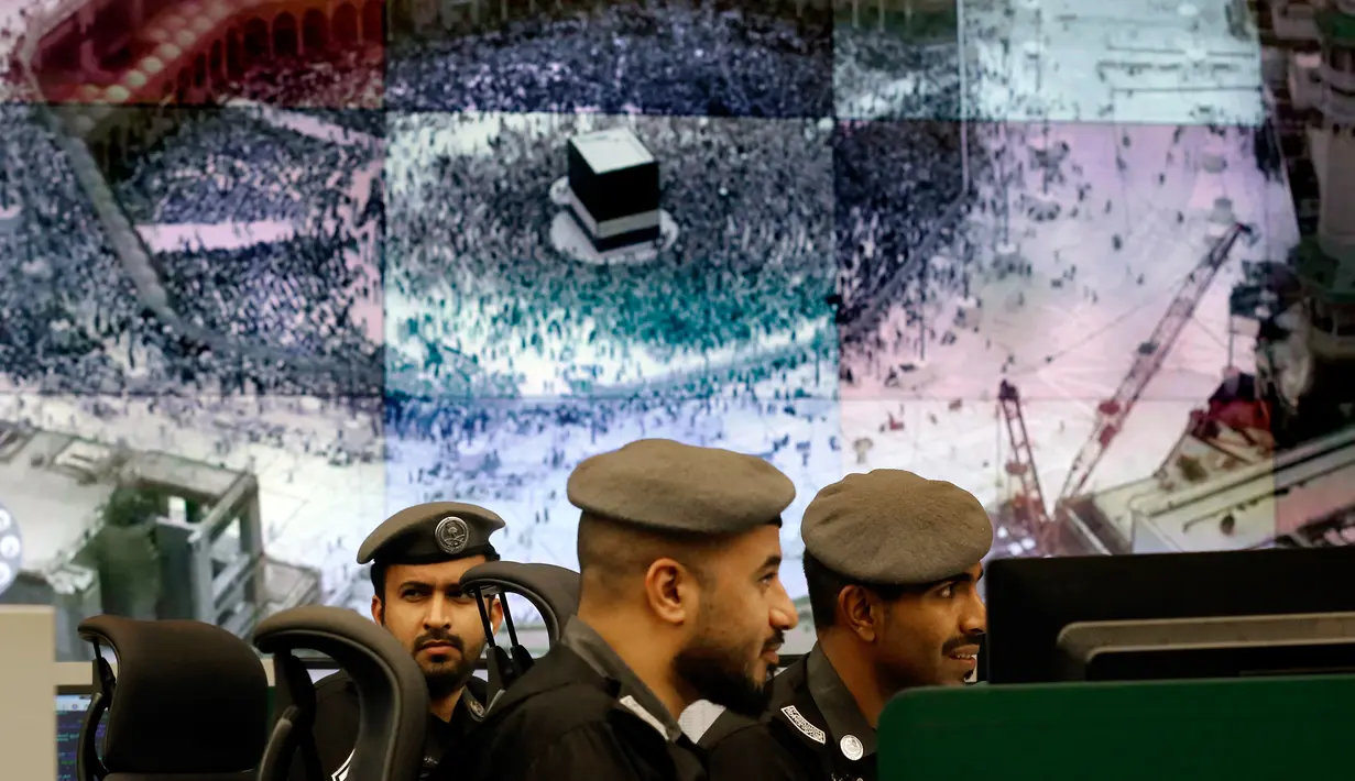 Sejumlah petugas kepolisian Arab Saudi memantau layar yang memperlihatkan Masjidil Haram di Pusat Pemantauan 911, Makkah, Selasa (6/8/2019). Teknologi yang digunakan oleh Pusat Pemantauan 911 termasuk terbaik di dunia. (AP Photo/Amr Nabil)