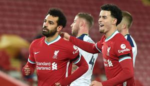Gelandang Liverpool, Mohamed Salah (kiri) melakukan selebrasi bersama Curtis Jones, usai mencetak gol pertama timnya ke gawang Tottenham Hotspur dalam laga lanjutan Liga Inggris 2020/21 pekan ke-13 di Anfield Stadium, Rabu (16/12/2020). Liverpool menang 2-1 atas Tottenham. (AFP/Peter Powell/Pool)