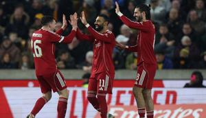 Striker Liverpool asal Mesir #11, Mohamed Salah (C), merayakan gol kedua mereka bersama bek Liverpool asal Skotlandia #26, Andrew Robertson (L), dan gelandang Liverpool asal Hongaria #08, Dominik Szoboszlai (R), selama pertandingan putaran kelima Piala FA Inggris antara Wolverhampton Wanderers dan Liverpool di stadion Molineux di Wolverhampton, Inggris tengah pada 7 Maret 2026. (Darren Staples/AFP)