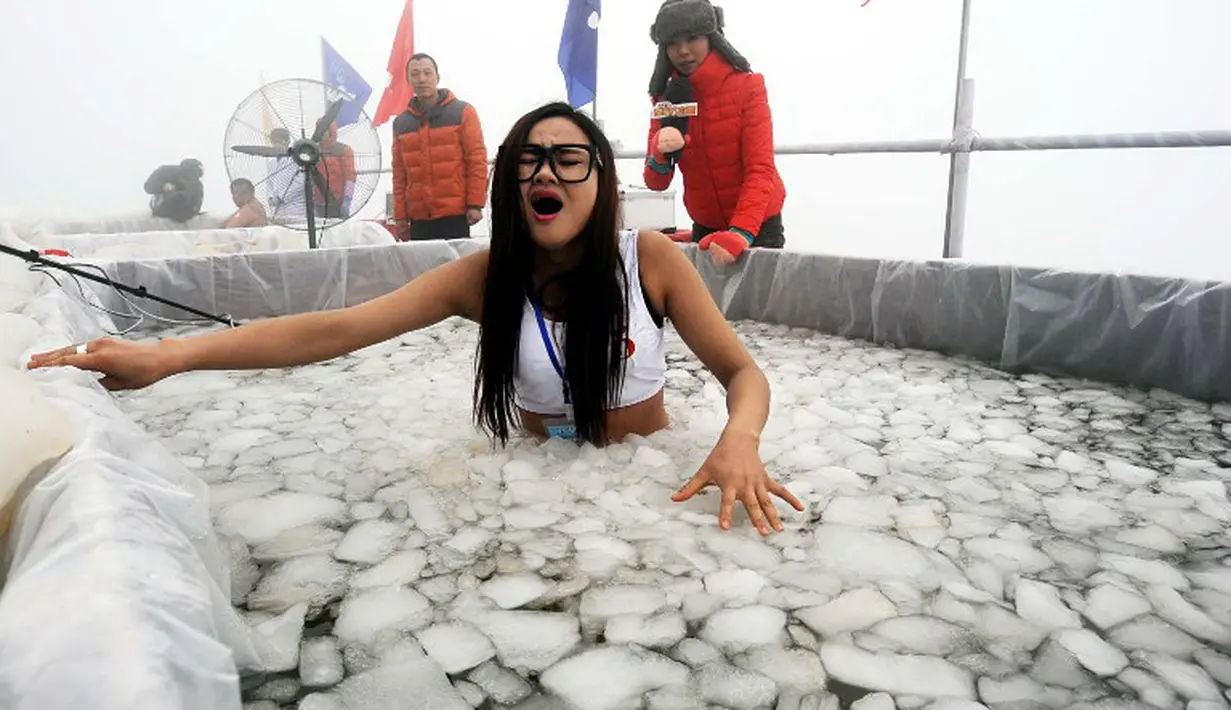 Sebuah acara berendam di kolam es digelar di Zhangjiajie, Tiongkok. Gambar ini diambil pada 25 Januari 2015. (AFP Photo)