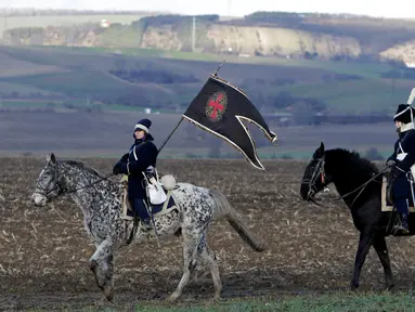 Sejumlah orang berpakaian tentara tahun 1800-an menunggang kuda untuk mengenang kembali pertempuran Austerlitz di dekat desa Moravian selatan Herspice, Republik Ceko (2/11). Mereka adalah orang-orang penggemar sejarah. (Reuters/David W Cerny)