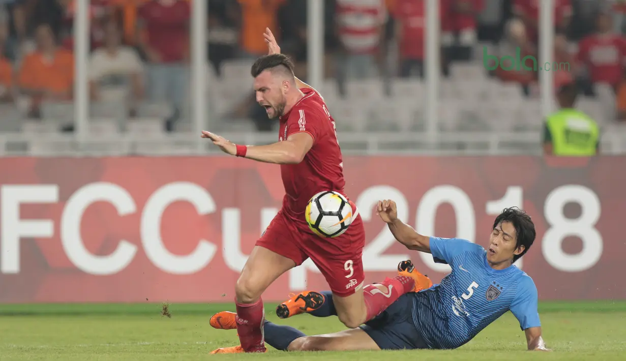 Pemain Persija Jakarta, Marko Simic (kiri) gagal melewati  pemain JDT pada laga grup H Piala AFC 2018 di Stadion Utama Gelora Bung Karno, Jakarta, Selasa (10/4/2018). Persija Jakarta menang 4-0.  (Bola.com/Nick Hanoatubun)