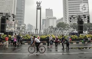 Warga beraktivitas saat car free day (CFD) di kawasan Bundaran HI, Jakarta, Minggu (29/12/2019). Kendati tidak seramai saat cerah, warga yang berlari, jalan santai, atau swafoto masih menjadi pemandangan di area CFD usai hujan mengguyur Jakarta. (Liputan6.com/Faizal Fanani)