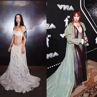 Jadi host di MTV VMA, Megan The Stallion tampil memukau kenakan black semi-sheer mermaid gown dengan dramatic skirt dari Nicole + Felicia. [@nicolefeliciacouture].