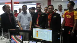 Menkominfo Rudiantara (kedua kiri) saat memantau traffic komunikasi di Gedung Indosat, Jakarta, Senin (4/7). (Liputan6.com/JohanTallo)