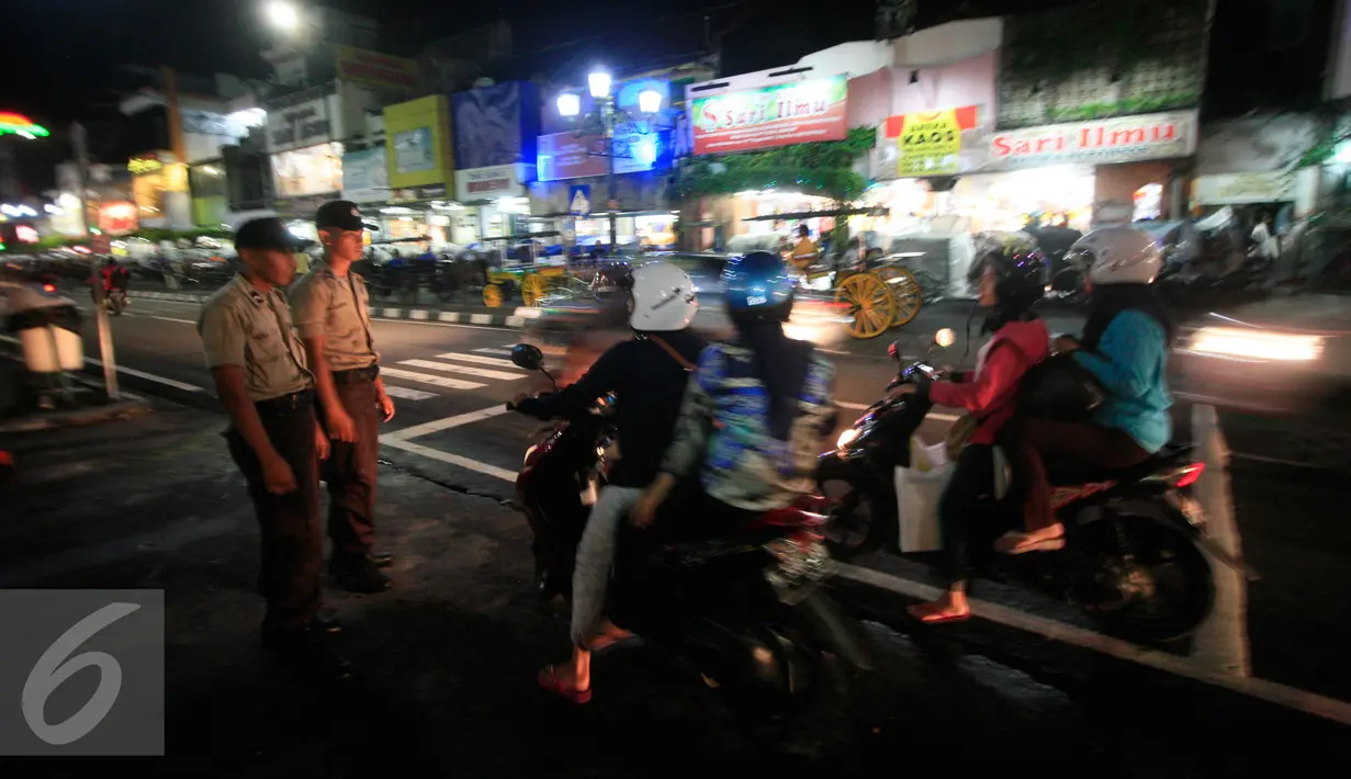 Petugas memberitahu kepada warga yang hendak parkir di kawasan pendestrian Malioboro, Senin (4/4). Penjagaan dilakukan untuk mengantisipasi kendaraan yang parkir di kawasan pendestrian yang telah ditutup sejak hari ini. (Liputan6.com/Boy Harjanto)