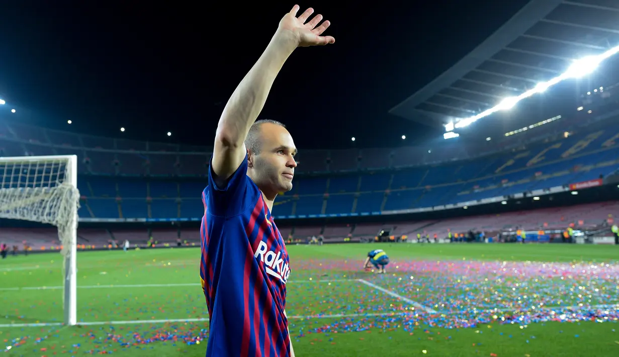 Andres Iniesta melambaikan tangan ke arah suporter pada laga terakhirnya bersama Bracelona di pertandingan pekan ke-38 La Liga melawan Real Sociedad, Minggu (20/5). Iniesta resmi meninggalkan Barcelona setelah 22 tahun berkarier di sana. (AFP/LLUIS GENE)
