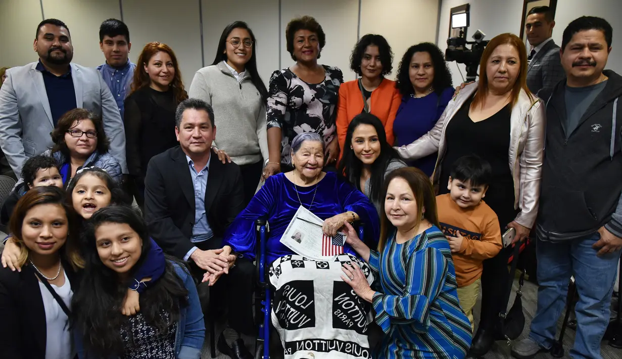 Maria Valles Bonilla berpose bersama keluarganya setelah menjadi warga negara Amerika Serikat di kantor Citizenship and Immigration Services AS di Fairfax, Virginia, 6 November 2018. Valles menjadi warga negara AS di usia 106 tahun. (MANDEL NGAN/AFP)