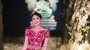 Krisdayanti tampak memukau dengan gaun panjang berwarna ungu tua yang dipadukan dengan motif khas Bali yang dominan di bagian atasan. Hiasan kepala sederhana namun anggun menambah daya tariknya. [@mamauthe/@3divaofficial].