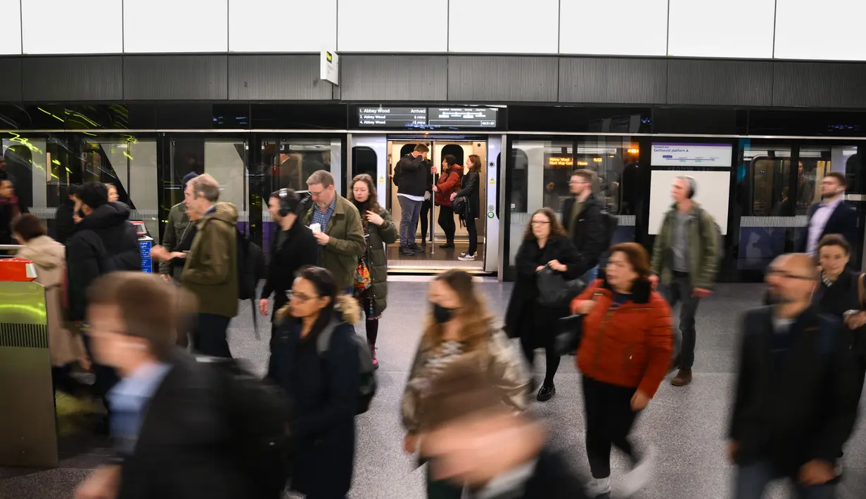 Penumpang tiba di Stasiun Canary Wharf Elizabeth Line yang baru dibuka di London Timur, Inggris, Senin (7/11/2022). Kereta bawah tanah ini sekarang memungkinkan penumpang untuk melakukan perjalanan melintasi ibukota tanpa harus berpindah stasiun. (Daniel LEAL / AFP)