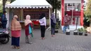 Warga antre untuk melakukan penarikan uang bantuan sosial tunai (BST) di ATM Bank DKI di Jakarta, Selasa (20/7/2021). BST sebesar Rp 600 ribu bagi warga DKI Jakarta yang terdampak pandemi COVID-19 langsung masuk ke rekening masing-masing penerima. (Liputan6.com/Angga Yuniar)