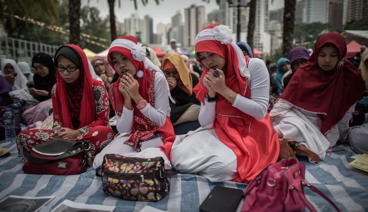 Suasana doa bersama ratusan TKI untuk Sumarti Ningsih dan Seneng Mujiasih, Hong Kong, Minggu (9/11/2014). (AFP PHOTO/Philippe Lopez)