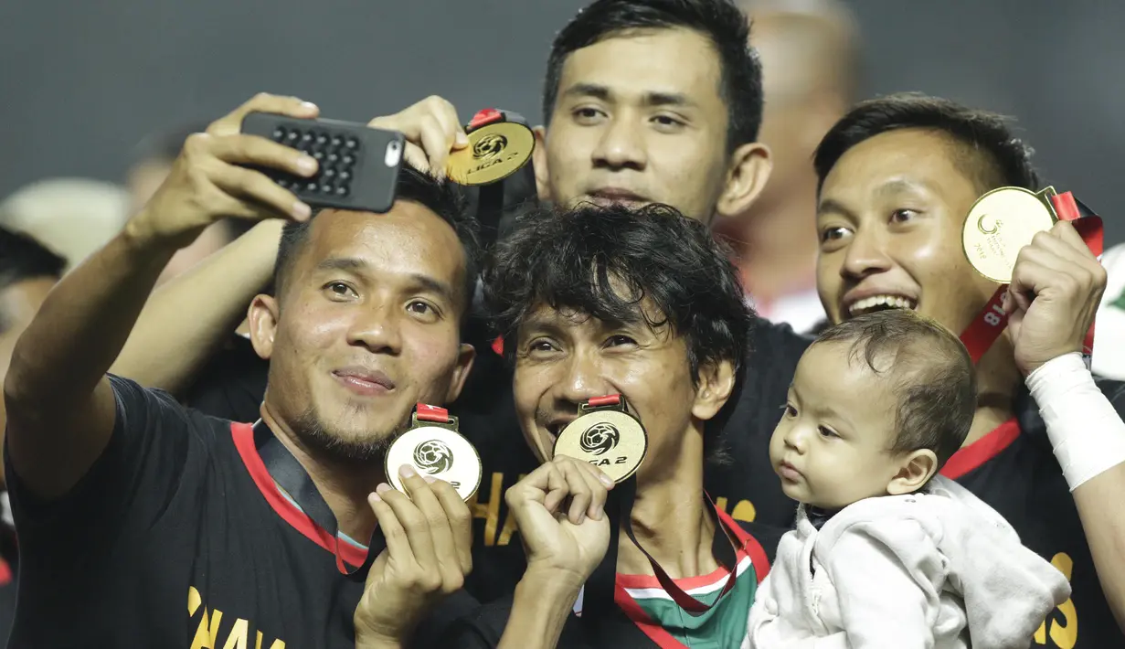 Bek PSS Sleman, Amarzukih, bersama rekan-rekannya merayakan juara Liga 2 usai menaklukkan Semen Padang pada laga Liga 2 di Stadion Pakansari, Jawa Barat, Selasa (4/12). PSS menang 2-0 atas Semen Padang. (Bola.com/M. Iqbal Ichsan)