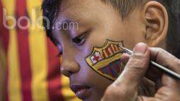 Seorang fans Barcelona mewarnai wajahnya sebelum nonton bareng bersama Bola.com dan Head & Shoulders di Senayan, Jakarta, Minggu (24/4/2017). (Bola.com/Vitalis Yogi Trisna)