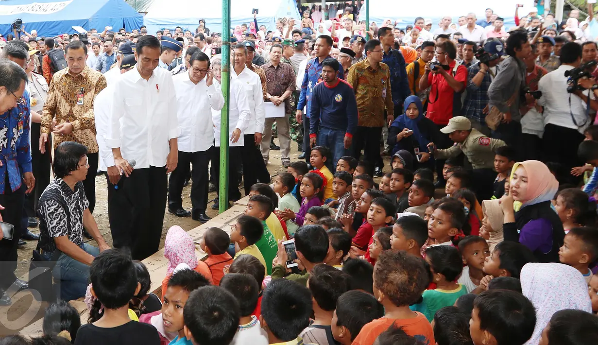 Presiden Joko Widodo (Jokowi) bersama Ketua Lembaga Perlindungan Anak Indonesia (LPAI) Seto Mulyadi (jongkok) menghibur para anak korban gempa Aceh di posko pengungsian di Pidie Jaya, Jumat (9/12). (Liputan6.com/Angga Yuniar)