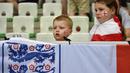 Dua suporter cilik asal Inggris tengah serius mnyaksikan laga timnya melawan Slovakia pada piala Eropa 2016 di Stadion Geoffroy-Guichard, Saint-Etienne,(20/6/2016). (AFP/Jeff Pachoud)