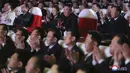 Pemimpin Korea Utara, Kim Jong-un (tengah) ditemani istrinya, Ri Sol Ju menonton pertunjukan di Pyongyang pada Selasa (16/2/2021). Istri Kim Jong-un muncul di hadapan publik untuk pertama kalinya setelah lebih dari setahun tidak terlihat. (Korean Central News Agency/Korea News Service via AP)